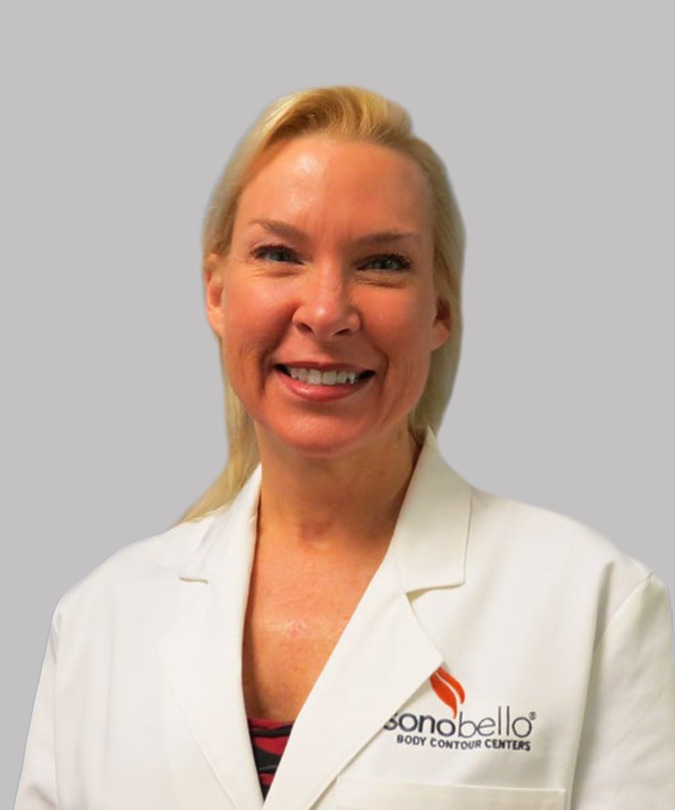 Smiling professional woman in a white lab coat against a gray background