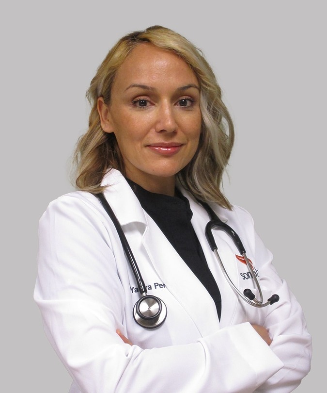Medical professional in a white coat with a stethoscope, looking confidently into the camera against a plain background.