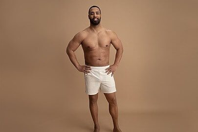 Male showcasing laser lipo fat removal results and sculpted chest