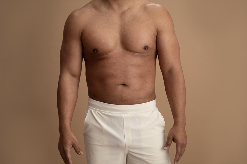 Closeup image of male chest and abs after laser liposuction procedure