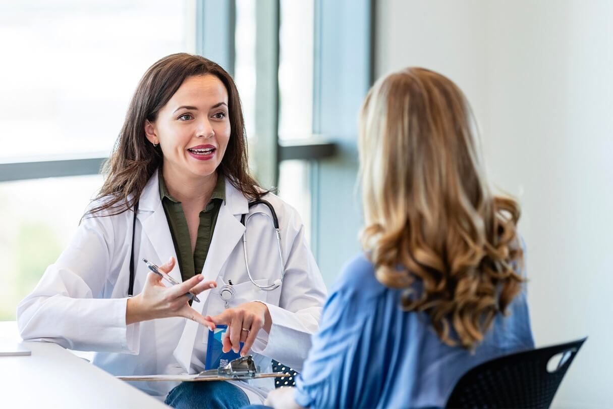 Surgeon and patient discuss minimally invasive lipo surgery