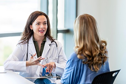Surgeon and patient discuss minimally invasive lipo surgery
