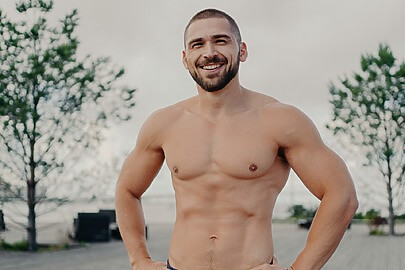 Man poses shirtless after laser liposuction