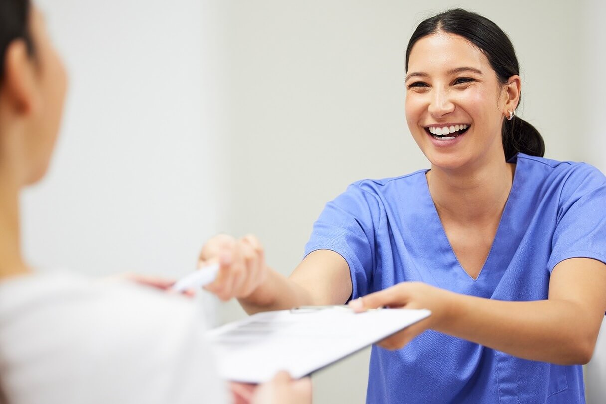 Signing paperwork before laser liposuction procedure