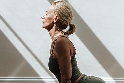 Menopausal woman stretching and engaging in healthy routines
