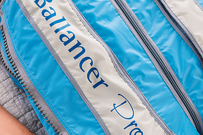 Person using a Ballancer Pro compression suit for relaxation therapy.