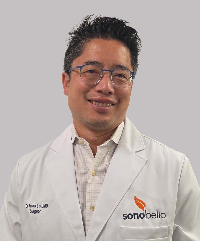A person wearing glasses and a white lab coat with the name "Dr. Frank Lau, MD" and "sono bello" logo visible.
