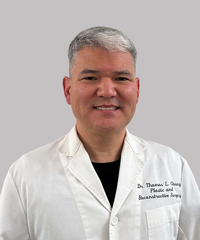 Sono Bello surgeon Thomas Chung, D.O. smiling in a white lab coat against a light grey background