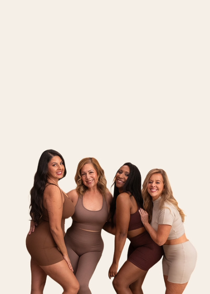 Four women smiling, wearing coordinated activewear sets, posing against a plain background.